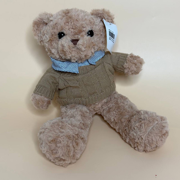 М’яка плюшева іграшка ведмедик у светрі коричневого кольору